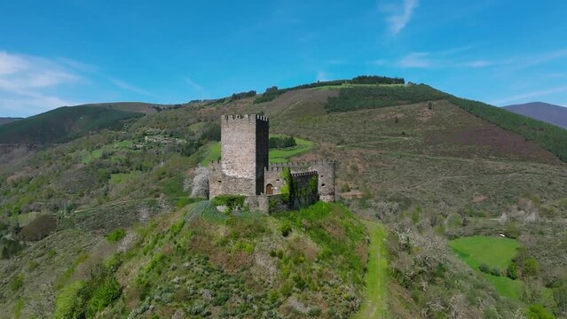 Doiras Castle On Top Of The Hill Surrounded By Mountains In Cervantes, Spain. - aerial shot