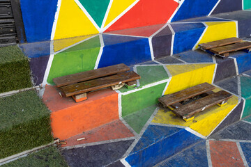 striking urban art installation featuring a set of stairs adorned with vibrant geometric patterns...