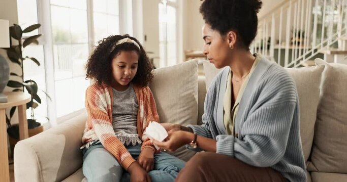 Mom, girl and home in sofa with sanitary pad for menstrual awareness, education and hygiene. Parent, kid and health or women conversation for child development, growth and care with support an help