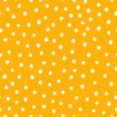 White polka dots on warm yellow background. Playful simple and abstract seamless pattern