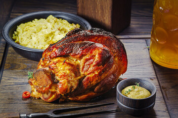 Eibein baked and served with sauerkraut. Served with mustard and stewed cabbage, smoked pork ham