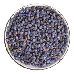 Dried juniper berries on plate above isolated