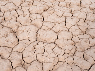deep cracks at the bottom of a dry water reservoir, top view, global warming concept