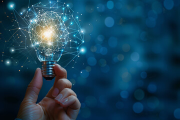 A hand is holding a light bulb with a glowing light inside