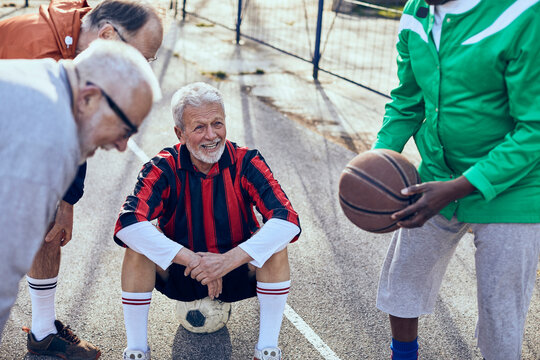 Elderly men playing sports on outdoor court
