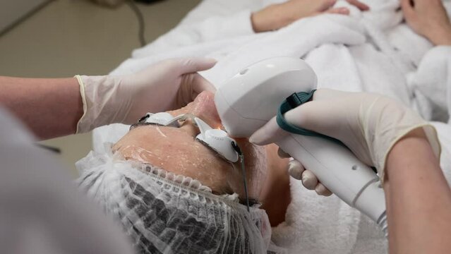 A woman receives IPL therapy in a beauty salon.