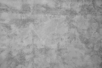 Close-up image of a textured concrete wall, highlighting the rough surface and details in monochrome.