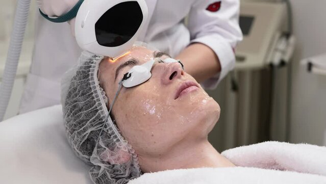 A woman receives IPL therapy in a beauty salon.