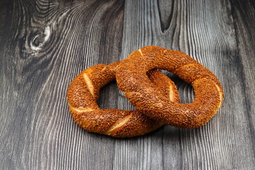 Turkish traditional bagel / simit with sesame on wooden table, turkish breakfast pastry concept