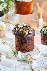 Festive Easter cake topped with chocolate glaze and golden walnuts, set in a bright holiday setting.