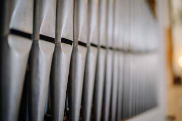Valmiera, Latvia - May 12, 2024 - Close-up of metal organ pipes in soft focus, showing detailed...