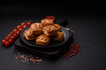 Triangular puffs with feta cheese, tomatoes with salt, spices and herbs
