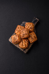 Triangular puffs with feta cheese, tomatoes with salt, spices and herbs