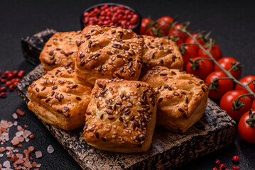 Triangular puffs with feta cheese, tomatoes with salt, spices and herbs
