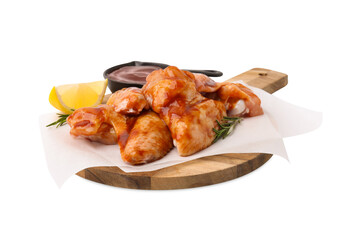 Board with marinade, raw chicken wings, rosemary and lemon isolated on white