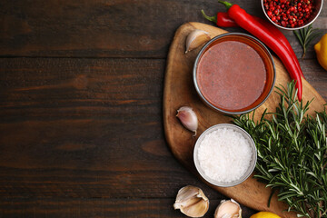 Fresh marinade and ingredients on wooden table, flat lay. Space for text