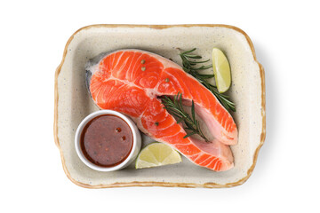 Fresh fish, lime, rosemary and marinade in baking dish isolated on white, top view
