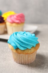 Delicious cupcakes with bright cream on gray table, selective focus