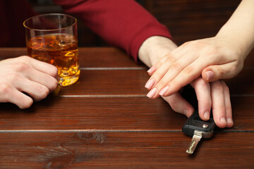 Woman stopping drunk man from taking car keys, closeup. Don't drink and drive concept