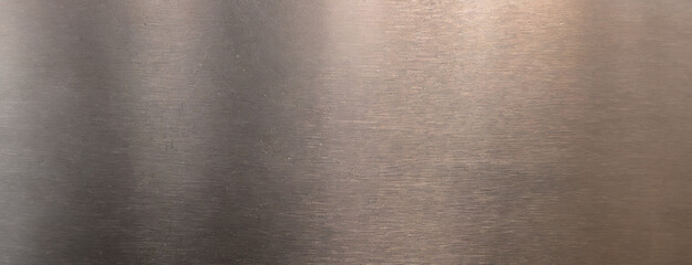 A close-up of a brushed metal surface with a smooth and reflective texture, highlighting its industrial and sleek qualities.