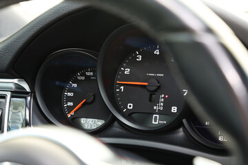 Speedometer and tachometer inside of modern car, closeup