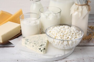 Different fresh dairy products on white wooden table