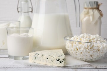 Different fresh dairy products on white wooden table