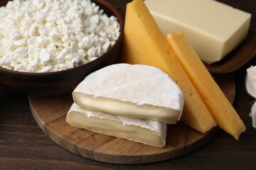 Dairy products. Different kinds of cheese and butter on wooden table, closeup