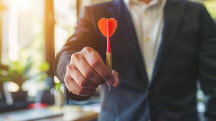 Businessman holding and throwing red arrow dart to virtual target dart board. Setup objectives and target for business investment concept.