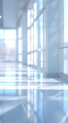 A hallway with empty white floor and multiple windows, providing ample natural light to the space