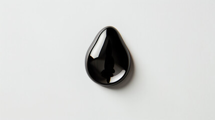  glossy black teardrop-shaped wall hanging, reflecting light on its polished surface, placed against an empty white background 