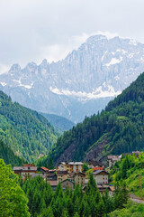 Small rural village nestled in the Dolomite Mountains Italy.Green morning scene of countryside in Swiss Alps, Bernese italian in the canton of Bern, Switzerland, Europe. Alpine mountain pasture