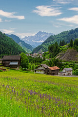 Small rural village nestled in the Dolomite Mountains Italy.Green morning scene of countryside in Swiss Alps, Bernese italian in the canton of Bern, Switzerland, Europe. Alpine mountain pasture