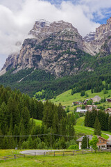 Small rural village nestled in the Dolomite Mountains Italy.Green morning scene of countryside in...