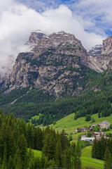 Small rural village nestled in the Dolomite Mountains Italy.Green morning scene of countryside in...