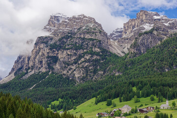 Naklejka premium Small rural village nestled in the Dolomite Mountains Italy.Green morning scene of countryside in Swiss Alps, Bernese italian in the canton of Bern, Switzerland, Europe. Alpine mountain pasture