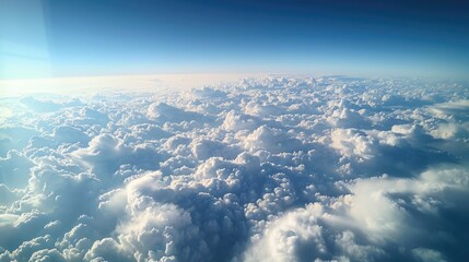 Fototapeta premium Expansive Mammatus Clouds Seen from Airplane Window with Clear Blue Sky and Sunlit Cloud Formations