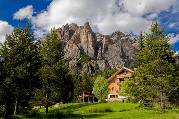 Alpine style house in the Italian Dolomite Mountains. Surrounded by pasture lands and rocky...