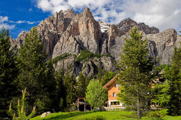 Alpine style house in the Italian Dolomite Mountains. Surrounded by pasture lands and rocky...