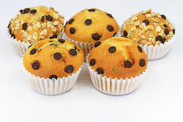 Delicious homemade muffins - with chocolate chips or with chocolate chips and oat flakes, white background