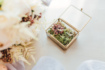 Wedding rings in a beautiful handmade glass box with flowers