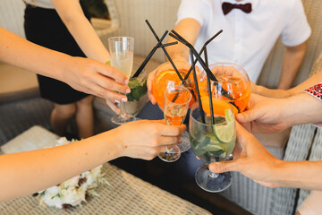 people with cocktails in hands, party with friends