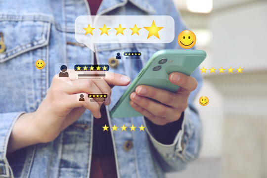Woman leaving service feedback with smartphone outdoors, closeup. Stars and emoticons near device