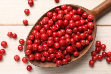 Aromatic spice. Red pepper in spoon on white wooden table, top view