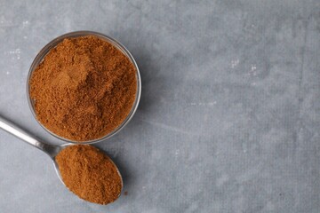 Ground red pepper on grey table, top view. Space for text