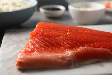 Fresh salmon for sushi on table, closeup