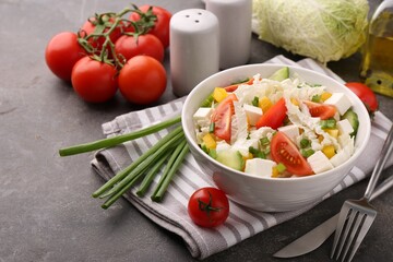 Tasty salad with Chinese cabbage served on grey table