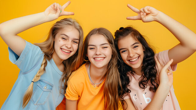 happy teen girls in casual shirt having fun showing peace gesture on yellow background childhood : Generative AI