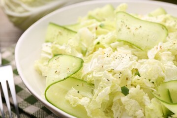 Tasty salad with Chinese cabbage, cucumber and green onion in bowl on table, closeup