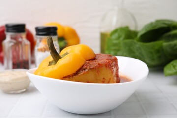 Delicious stuffed bell pepper on white tiled table